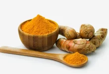 turmeric powder in a wooden bowl