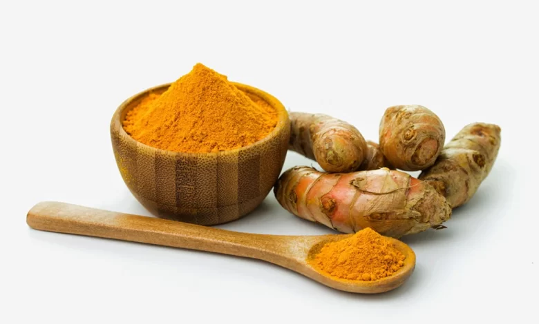turmeric powder in a wooden bowl