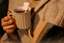 women holding cup of tea